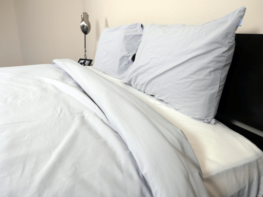 特写的床头床单套，显示羽绒被，枕头，和适合的床单